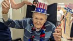 Resident smiles with his American Top hat to celebrate America.
