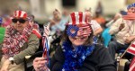 Carmelite Sisters residents pose with American flags during an America’s 250th anniversary celebration.