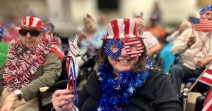 Carmelite Sisters residents pose with American flags during an America’s 250th anniversary celebration.